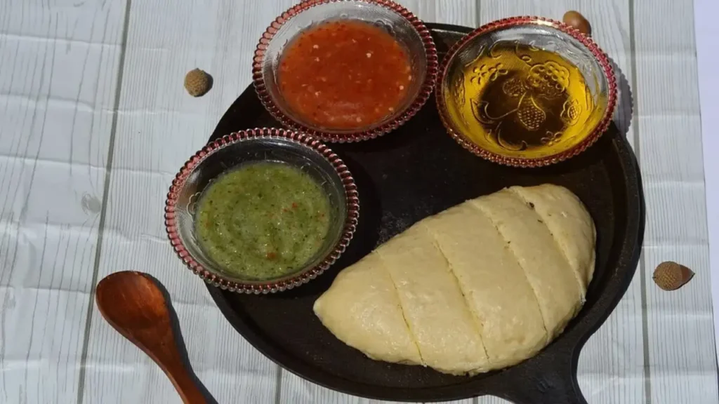 Traditional Himachali dish Siddu, steamed wheat buns stuffed and served with clarified butter (ghee) and chutney.